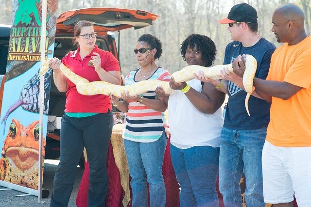 Residents holding a snake in Reptiles Alive demonstration