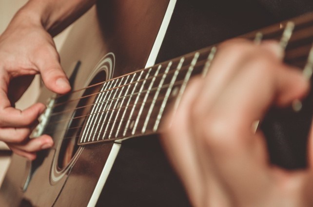 Strumming a guitar