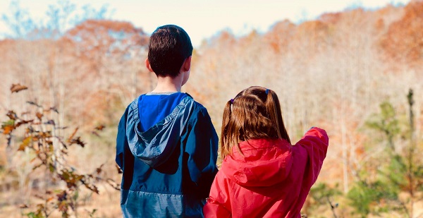 kids walking along trail in autumn