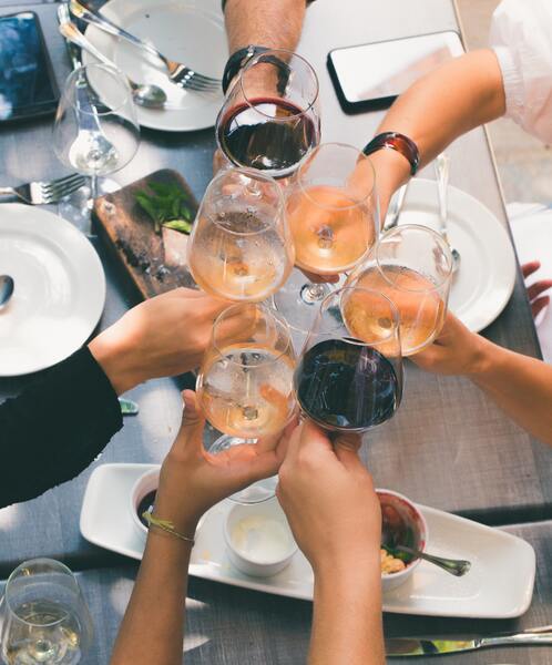 group of people toasting with wine glasses