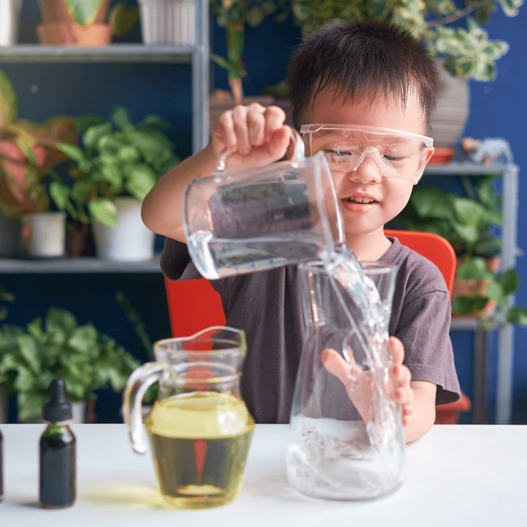 Boy pouring water into vase