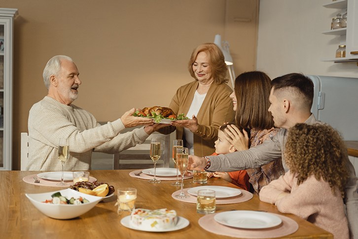 Adults enjoying Thanksgiving meal