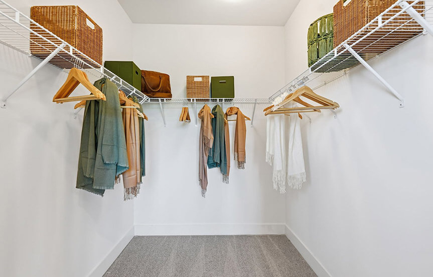 Scarlet primary bedroom walk-in closet built by Brookfield Residential at Cascades within Embrey Mill