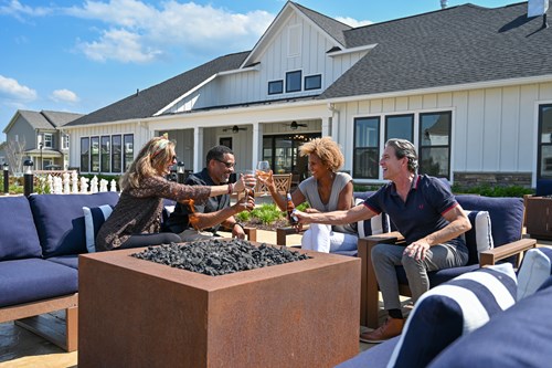 Residents toast around the outdoor fire pit at the Cascades Clubhouse in Embrey Mill, a 55+ community in Stafford, VA.